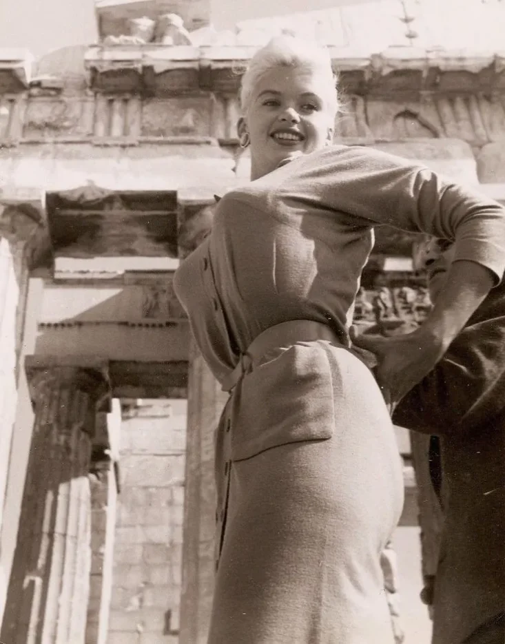 American actress, singer, nightclub entertainer, and Playboy Playmate Jayne Mansfield standing in front of the Parthenon on the Acropolis of Athens in 1957