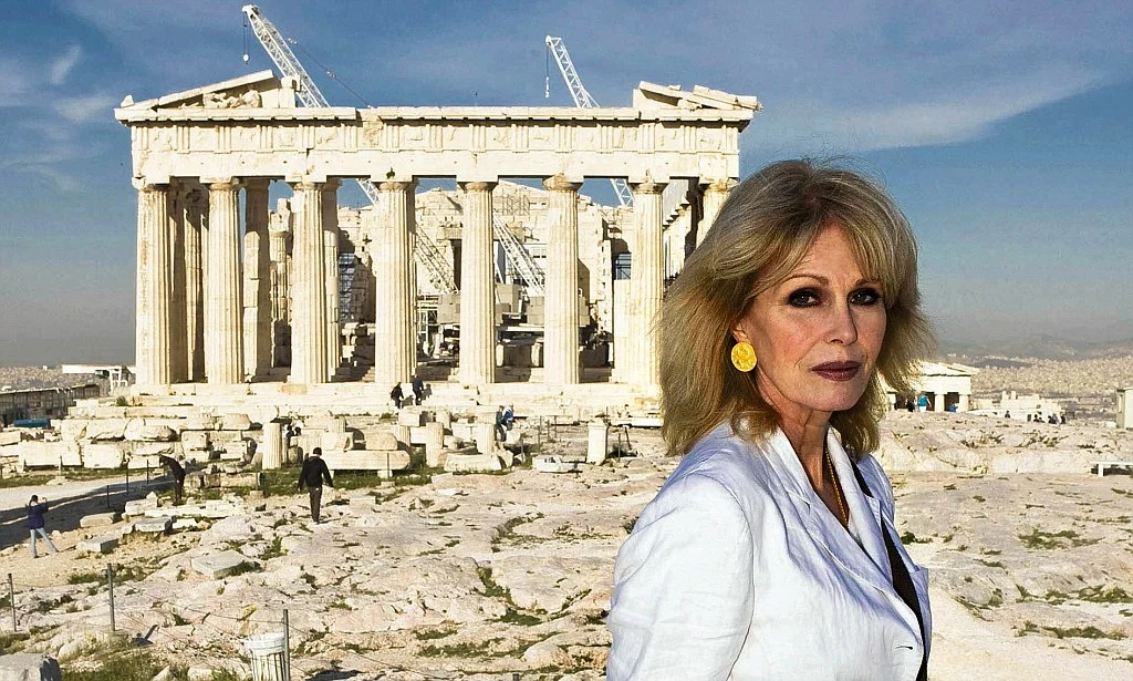 English actress, presenter, former model, author, television producer, and activist Joanna Lumley standing in front of the Parthenon on the Acropolis of Athens in 2011