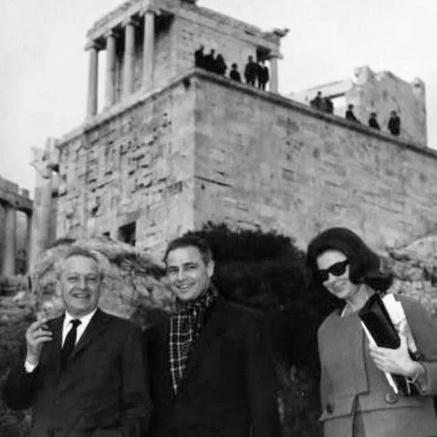 American actor Marlon Brando standing just below the Temple of Athena Nike next to the Parthenon on the Acropolis of Athens in 1958