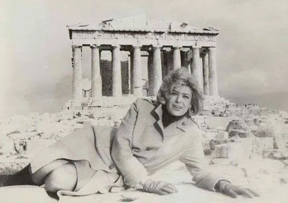 Greek actress, singer, activist, and politician Melina Mercouri laying in front of the Parthenon on the Acropolis of Athens in 1982