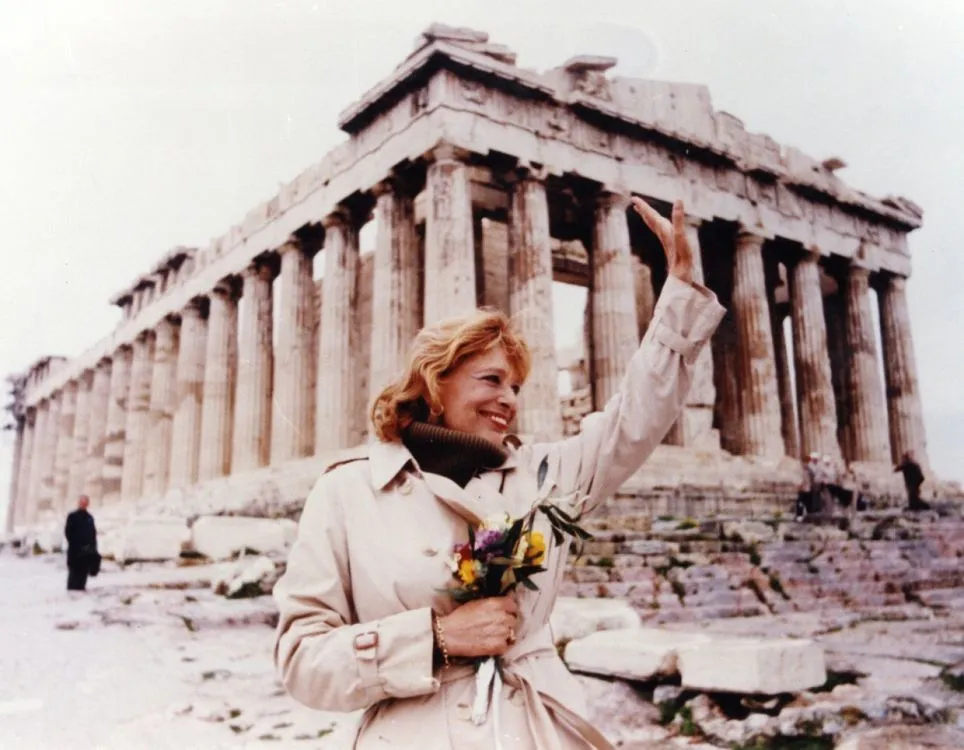 Greek actress, singer, activist, and politician Melina Mercouri waving to the crowd at the Parthenon on the Acropolis of Athens in 1982