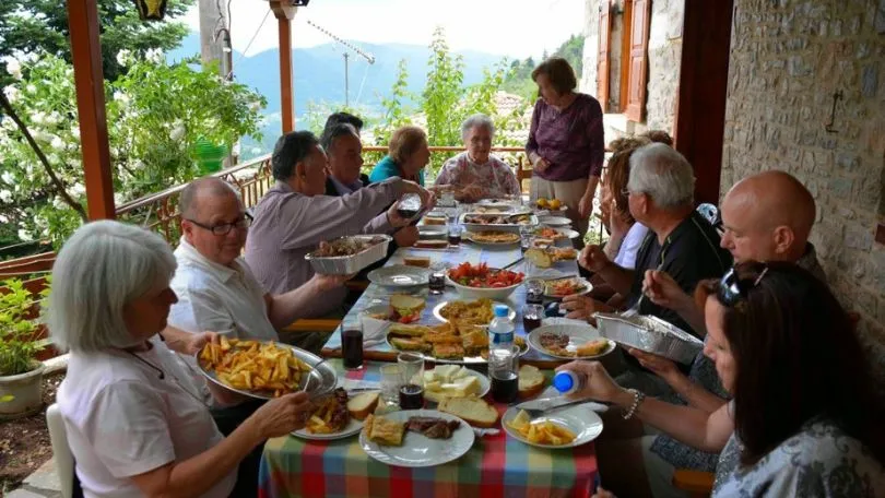 Three generations of a Greek family sitting around the same table for dinner