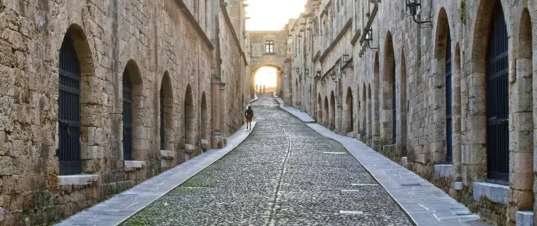 Looking down the medieval cobbled street of the Street of the Knights of Rhodes, Greece. Notive the many archways left and right of the street.