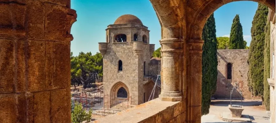 inside two archways and looking out at the domed tower at the Filerimos Monastery on the Greek island of Rhodes in the Dodecanese