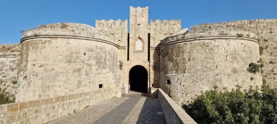 Standing on the bridge and walkway looking at the archway entrance to the Medieval City of Rhodes