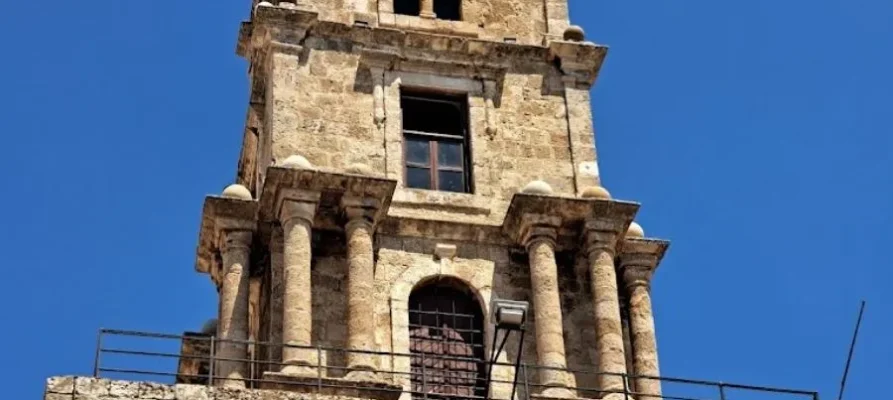 looking up at the famous stone clock tower at the Medieval City of Rhodes