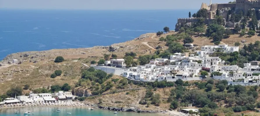 Lindos Bay and the whitewahsed houses of Lindos Village on Rhodes, Dodecanese