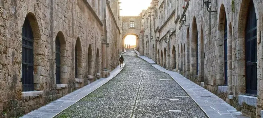 Looking down the medieval cobbled street of the Street of the Knights of Rhodes, Greece. Notive the many archways left and right of the street.