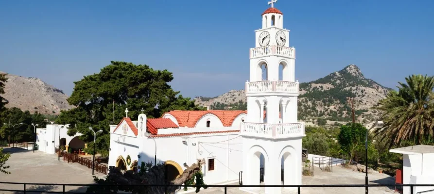 The whie monastery with it's tower and red slate roof of the Tsambika Monastery on Rhodes, Greece