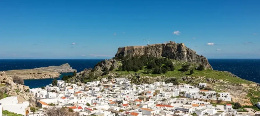 The whitewashed houses of Lindos Village at the base of Lindos Acropolis on the Greek island of Rhodes in the Dodecanese