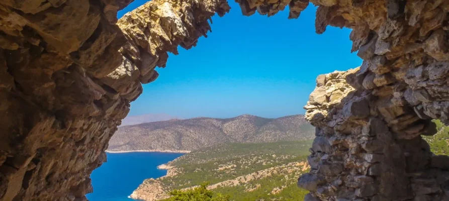 Looking through an arch of of Monolithos Castle on the Greek island of Rhodes in the Dodecanese, with a view of the sea in the background