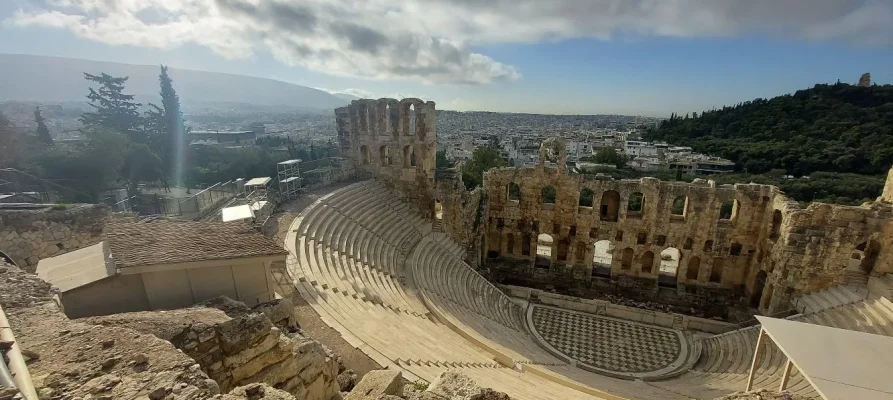 Odeon of Herodes Atticus on the Acropolis of Athens. In the background is the Filopappous Monument on Filopappous Hill Athens Greece