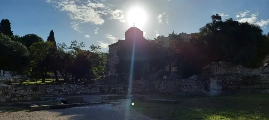 The sun rising behind the church of the holy apostles in the Ancient Agora of Athens