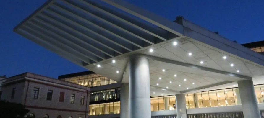 Looking underneath the overhang of the Acropolis Museum building at night