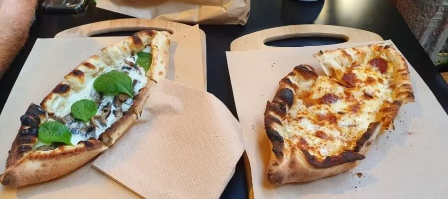 Pizza boats served on paper in Athens as part of the Street Food Tasting Tour in Athens