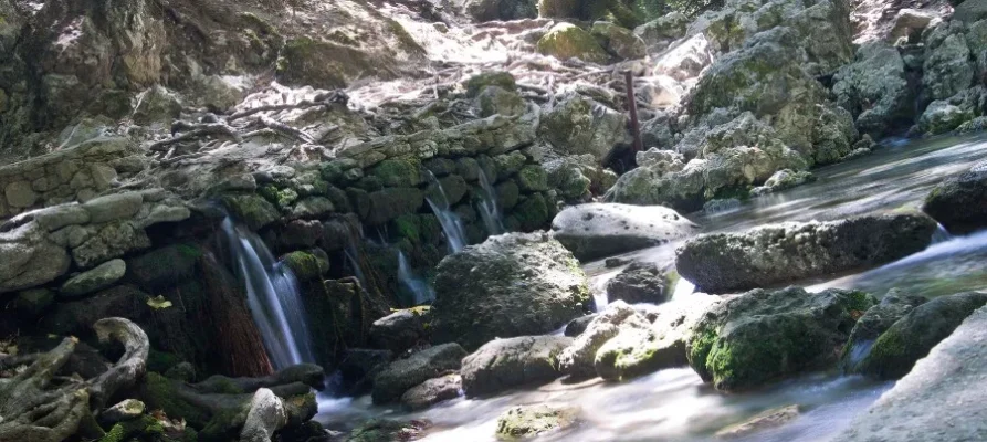 Four very small waterfalls falling over a little rick embankment at the Seven Springs in Rhodes, Greece