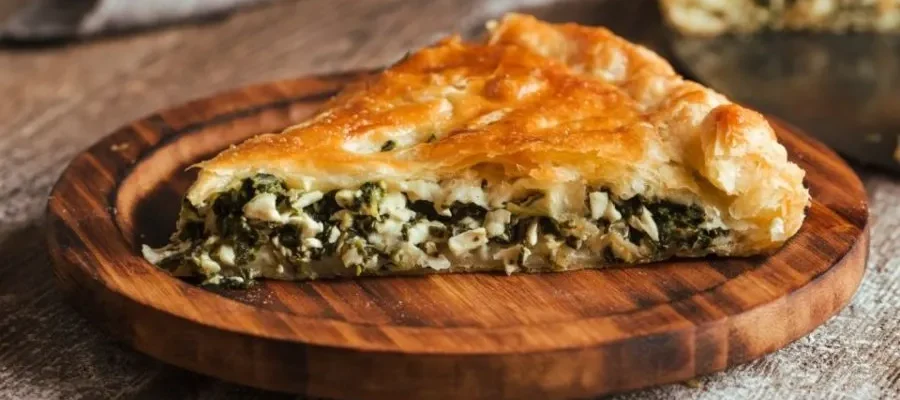 A beautiful slice of Spanakopita, the famous spinach and cheese pie. Served as part of thre Street Food Tasting Tour in Athens