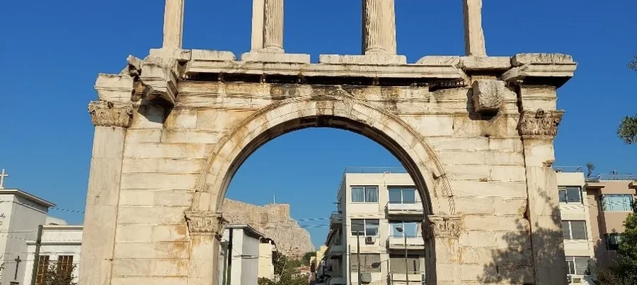 Close-up of the front of the Arch of Hadrian in Athens with the Acropolis of Athens in the background through the Arch