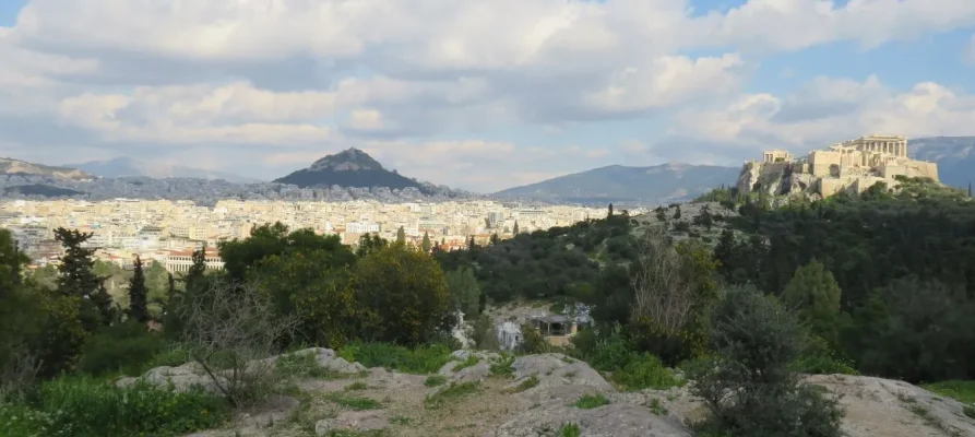 The Acropolis of Athens as viewed from the Pnyx. Lycabettus Hill is in the background on the left